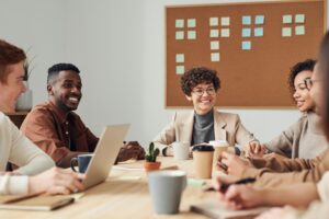 A diverse group of professionals collaborating during a brainstorming session in a modern office setting.